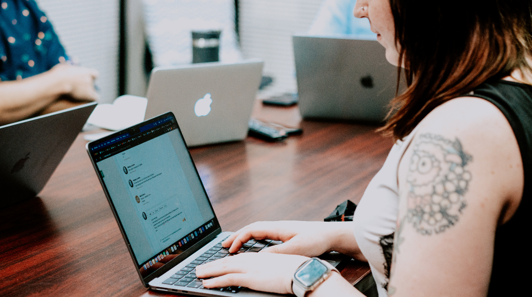 Woman working on laptop in board room